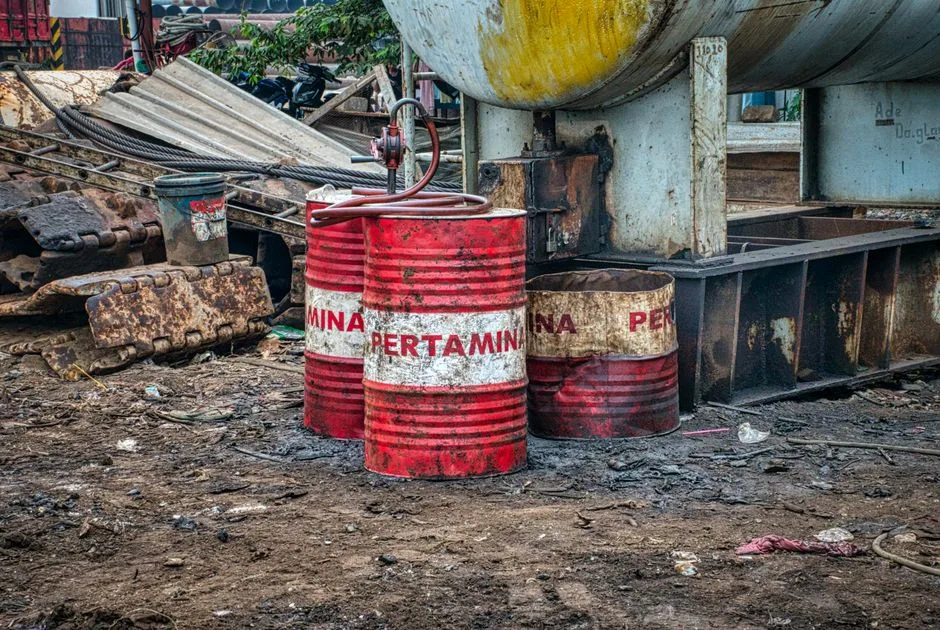 Oil prices slip over $1 as analysts cut demand forecasts